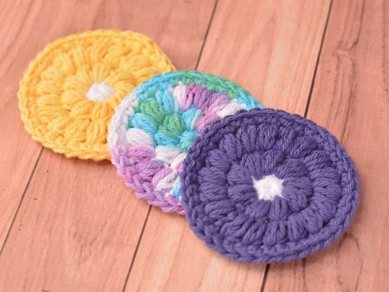 Colorful crochet face scrubbies displayed. Crochet Face Scrubbie Pattern – Cotton Face Scrubbies by Remington Lane Crochet