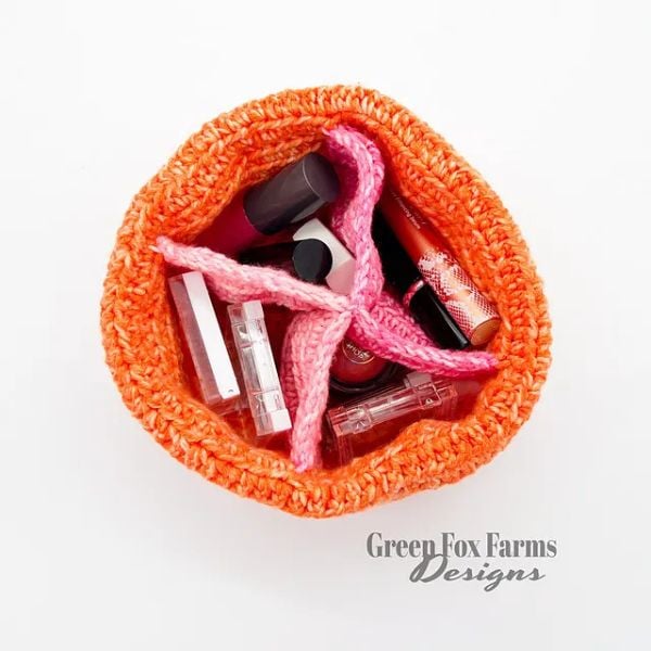 Colorful crochet bag with cosmetics inside. Fourfold Fate Crochet Divided Pocket Bag Pattern Free