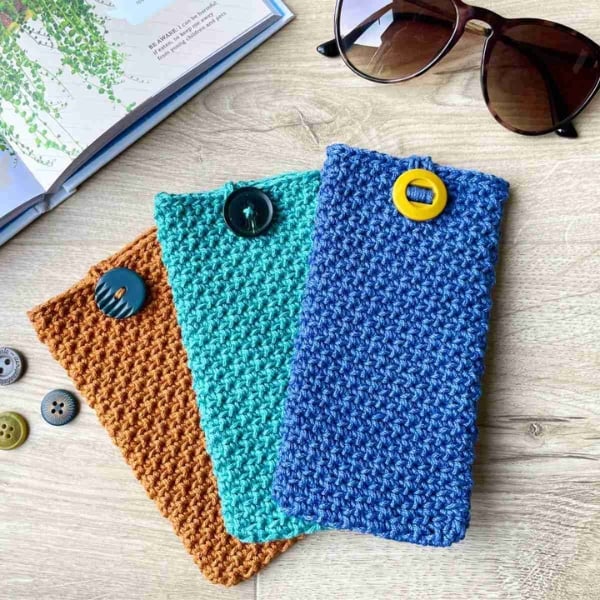 Colorful crocheted glasses cases displayed. Glasses Case Crochet Pattern by Dreamee Crochet