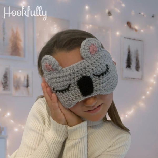Girl wearing a cute koala eye mask. Koala Eye Mask Crochet Pattern by Hookfully